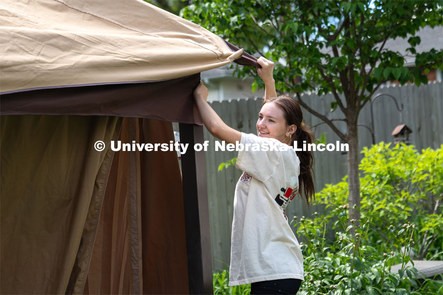 Alyssa Dunlap of Tri Delta attaches the outer curtain of a pergola during the Big Event. May 4, 2024. Photo by Kirk Rangel for University Communication.